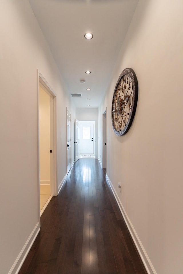 corridor featuring dark wood-type flooring