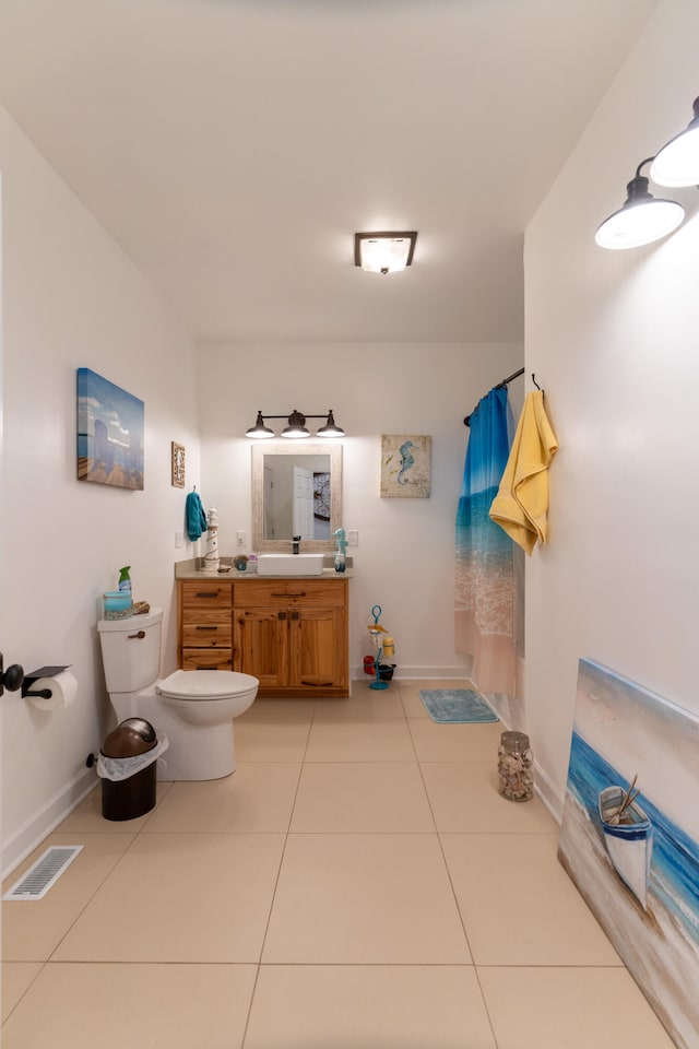 bathroom featuring vanity, curtained shower, toilet, and tile patterned floors