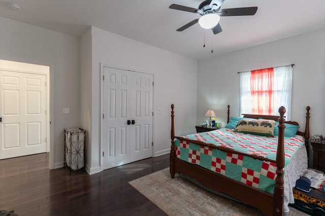 bedroom with dark wood-type flooring, ceiling fan, and a closet