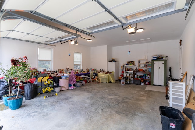 garage with a garage door opener and white fridge