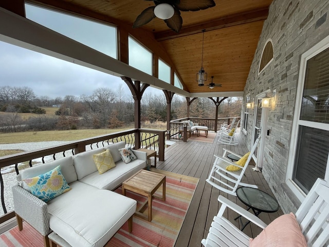 wooden deck with ceiling fan and outdoor lounge area