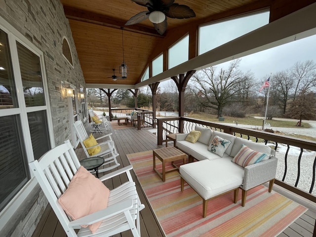 wooden deck with outdoor lounge area and ceiling fan