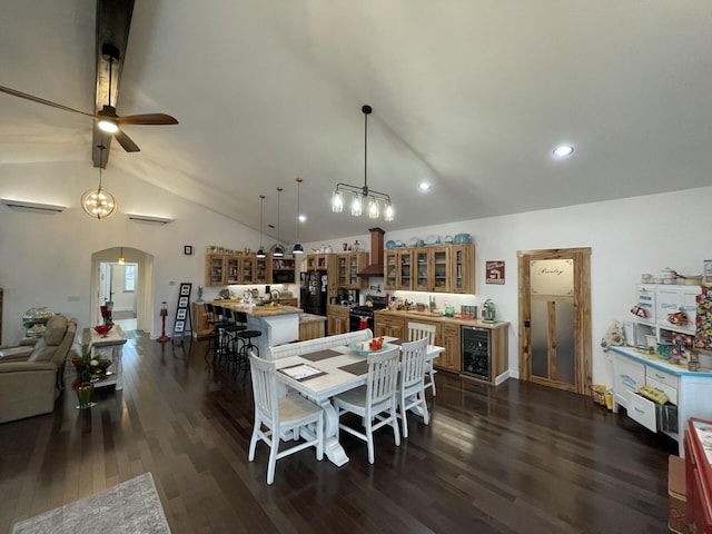 dining area with lofted ceiling with beams, dark wood-type flooring, wine cooler, and ceiling fan