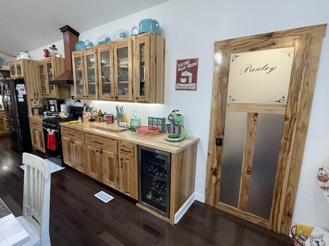 kitchen featuring wooden counters, dark wood-type flooring, beverage cooler, and black appliances