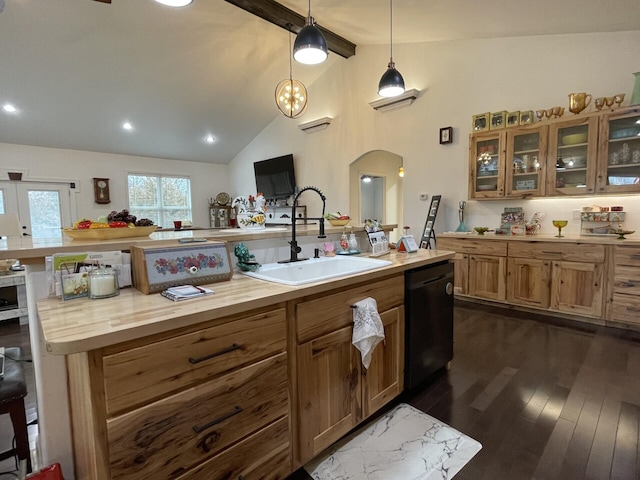 kitchen with dark hardwood / wood-style floors, pendant lighting, lofted ceiling with beams, dishwasher, and sink