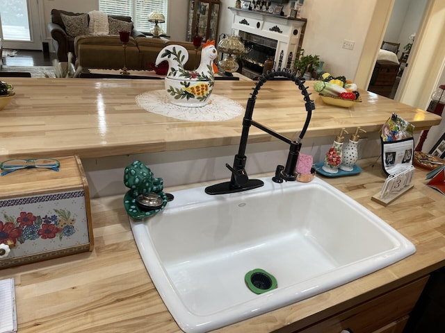 room details with sink and a tile fireplace