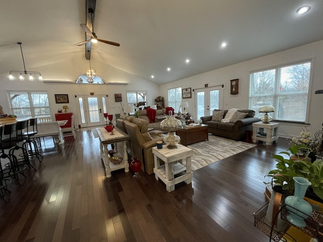 living room with dark hardwood / wood-style flooring, vaulted ceiling with beams, and french doors