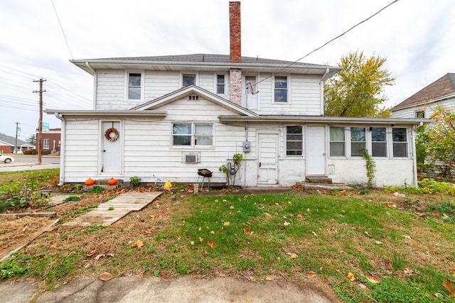 back of house featuring a yard