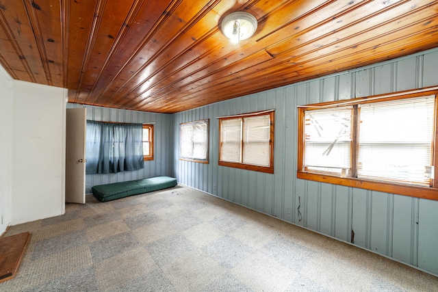 unfurnished sunroom with wood ceiling