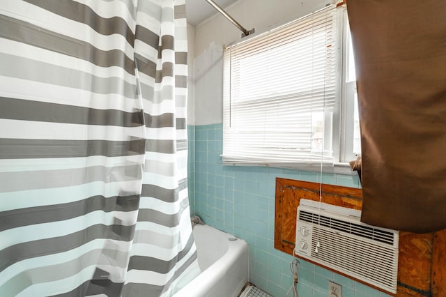 bathroom featuring tile walls and shower / bath combination with curtain