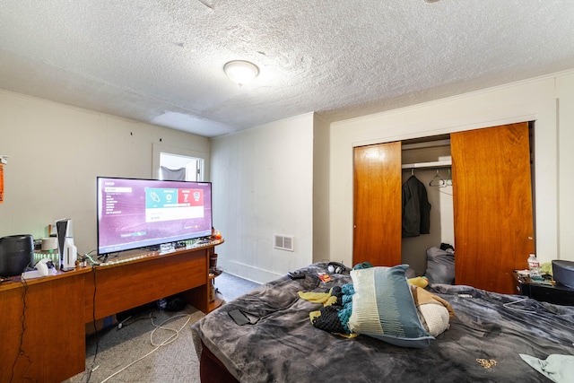 carpeted bedroom featuring a textured ceiling and a closet