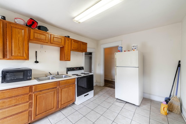 kitchen featuring sink, white appliances, and light tile patterned floors