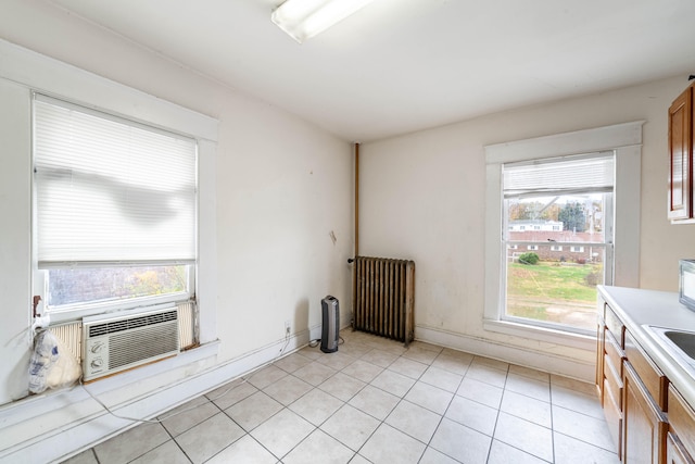 kitchen featuring light tile patterned floors, cooling unit, and radiator heating unit