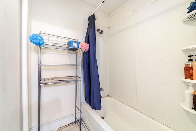 bathroom featuring ornamental molding and shower / bathtub combination with curtain