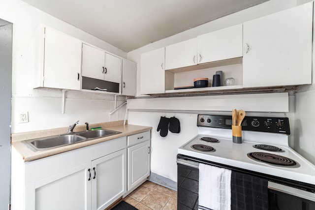 kitchen featuring sink, white cabinetry, white electric range, and light tile patterned flooring