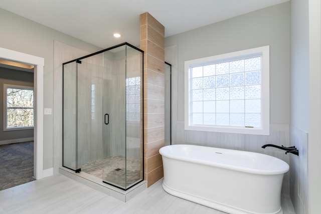 bathroom with a wealth of natural light and independent shower and bath