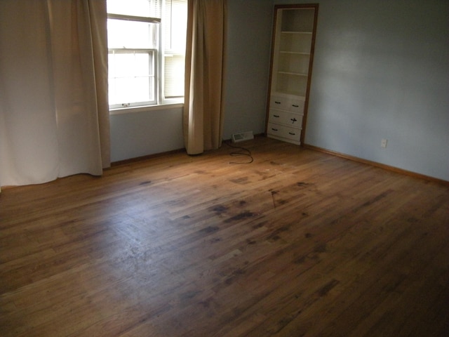 unfurnished bedroom featuring dark hardwood / wood-style floors