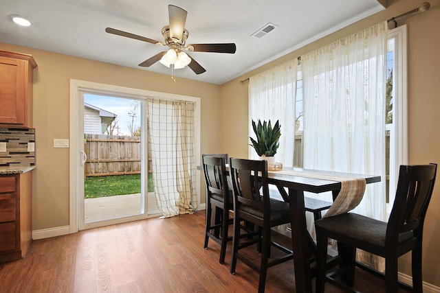 dining area with plenty of natural light, wood-type flooring, and ceiling fan