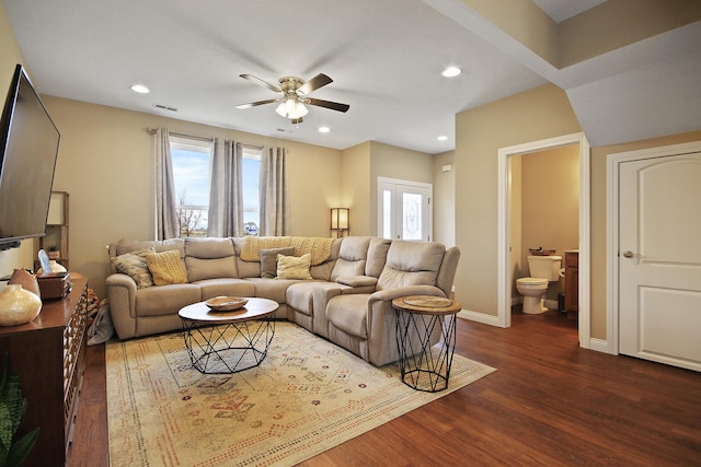 living room featuring dark hardwood / wood-style flooring, a healthy amount of sunlight, and ceiling fan