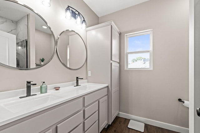 bathroom featuring a shower, wood-type flooring, and vanity