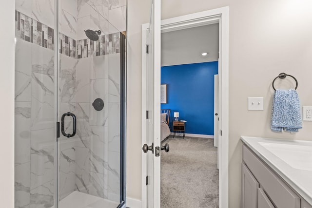 bathroom featuring vanity and a shower with door