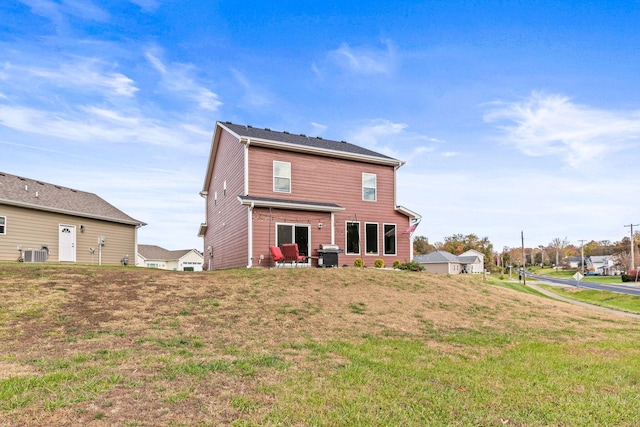 back of property featuring a patio, central AC unit, and a yard