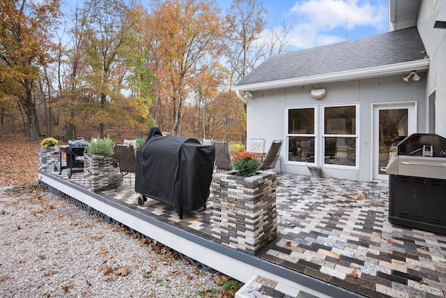 deck featuring a patio area and a grill