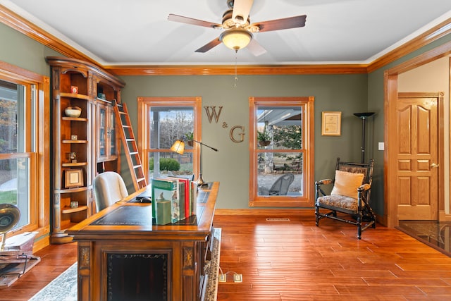 home office with light hardwood / wood-style flooring, ornamental molding, and ceiling fan