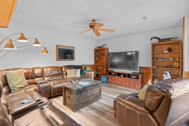 living room with light wood-type flooring and ceiling fan