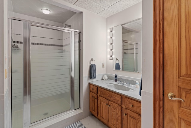 bathroom featuring vanity, walk in shower, and tile patterned flooring