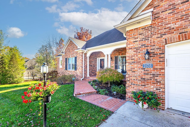 view of exterior entry featuring a lawn