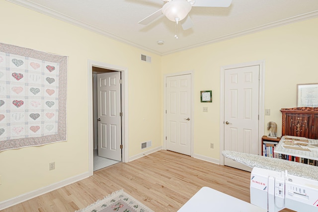 bedroom with ceiling fan, wood-type flooring, and crown molding