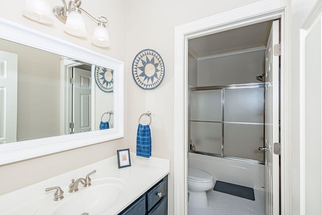 full bathroom with vanity, toilet, and bath / shower combo with glass door