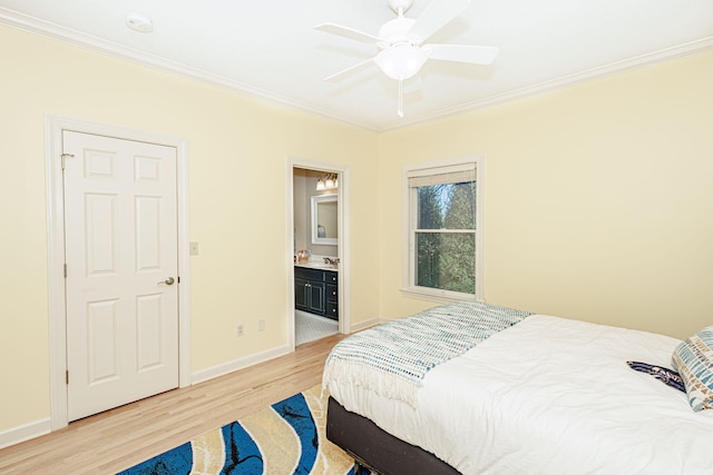 bedroom featuring connected bathroom, light hardwood / wood-style floors, ceiling fan, and crown molding