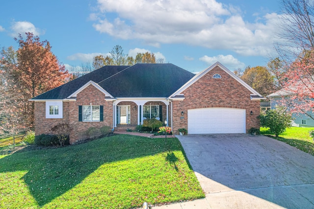 view of front of property with a front yard and a garage