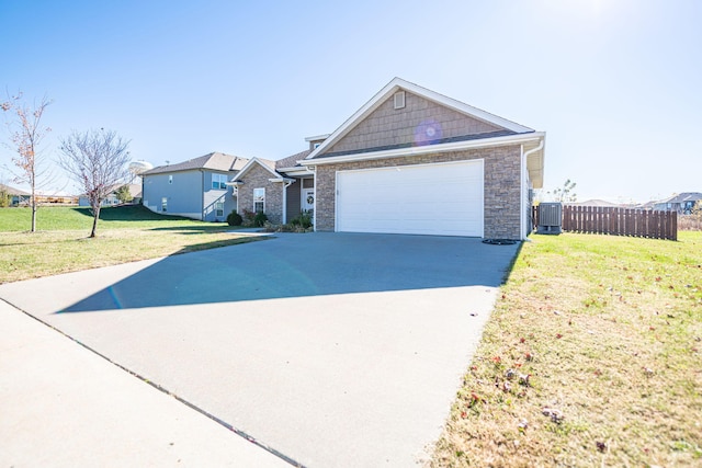 ranch-style house with a garage, central air condition unit, and a front lawn