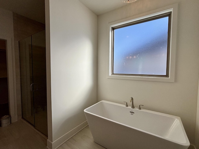 bathroom with plus walk in shower and a healthy amount of sunlight