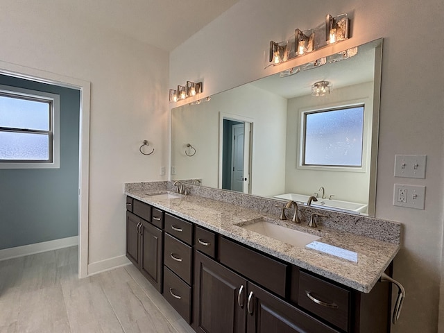 bathroom with a bath and vanity