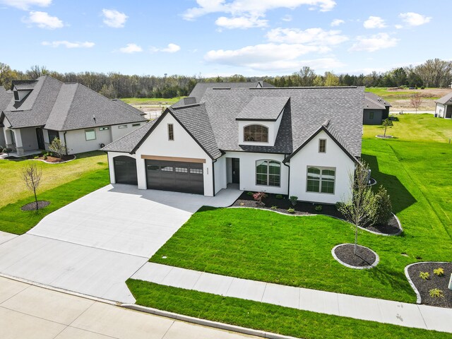 6504 Walsby Dr, Columbia, MO 65201 - french country style house with roof with shingles, driveway, an attached garage, a front yard, and stucco siding