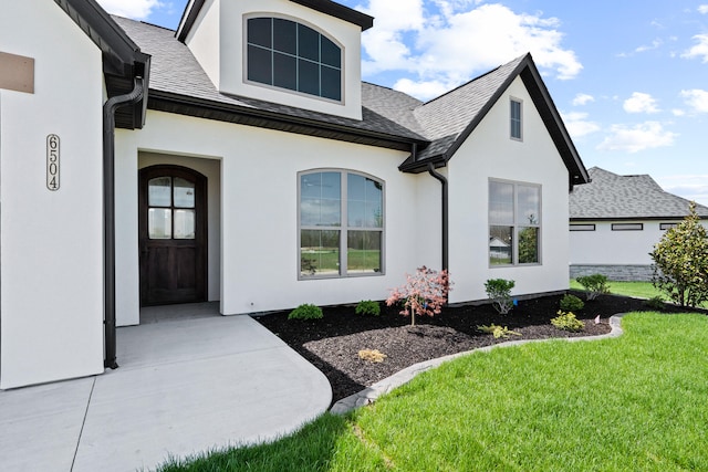 6504 Walsby Dr, Columbia, MO 65201 - property entrance with a shingled roof, a yard, and stucco siding