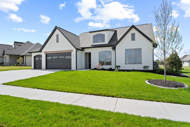 6504 Walsby Dr, Columbia, MO 65201 - french country home with stucco siding, a front lawn, concrete driveway, and a garage