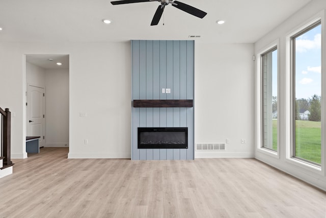 6504 Walsby Dr, Columbia, MO 65201 - unfurnished living room featuring wood finished floors, visible vents, and a wealth of natural light
