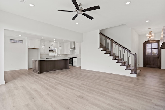 6504 Walsby Dr, Columbia, MO 65201 - unfurnished living room featuring recessed lighting, stairway, and light wood finished floors