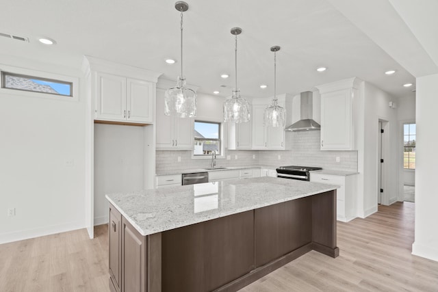 6504 Walsby Dr, Columbia, MO 65201 - kitchen with a sink, stainless steel appliances, wall chimney exhaust hood, baseboards, and visible vents