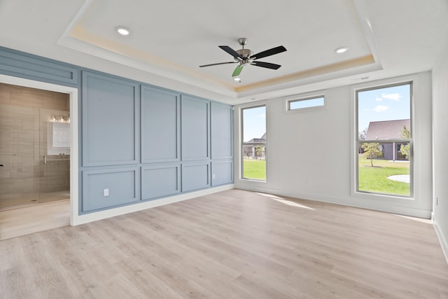 6504 Walsby Dr, Columbia, MO 65201 - unfurnished bedroom featuring light wood-type flooring, recessed lighting, a raised ceiling, and connected bathroom
