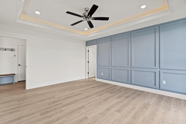 6504 Walsby Dr, Columbia, MO 65201 - unfurnished bedroom with recessed lighting, a raised ceiling, light wood finished floors, and ceiling fan