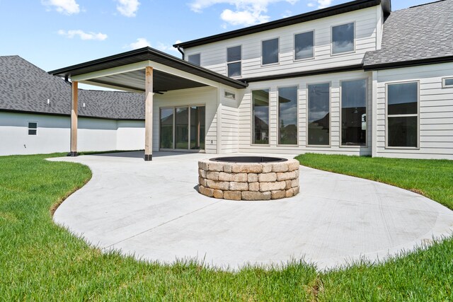 6504 Walsby Dr, Columbia, MO 65201 - back of house with a yard, a shingled roof, a patio, and an outdoor fire pit