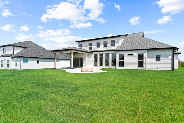 6504 Walsby Dr, Columbia, MO 65201 - rear view of property featuring roof with shingles, a patio, an outdoor fire pit, and a lawn