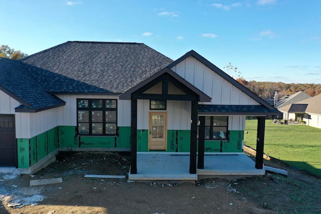 view of front of house featuring covered porch and a front lawn