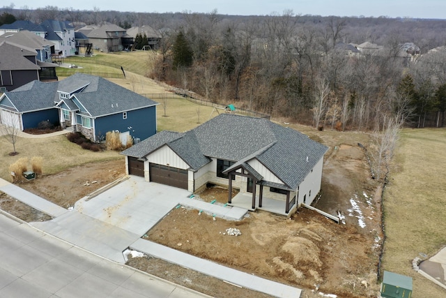 drone / aerial view featuring a forest view